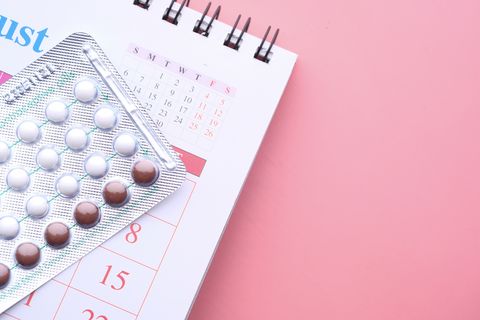 birth control pills on pink background  high angle view