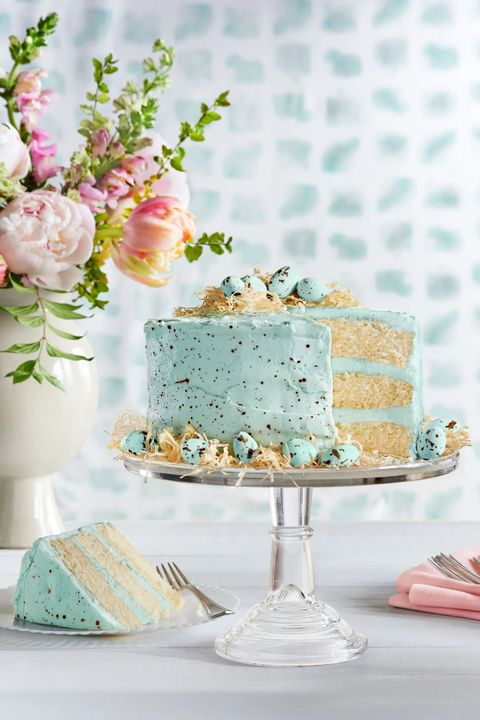 three layer speckled malted coconut cake with speckled light blue frosting