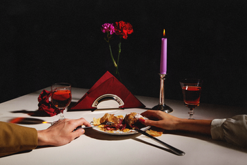 a romantic dinner setup featuring shared food and drinks