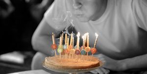boy blowing out birthday candles on cake