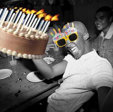 man holding cake with birthday glasses