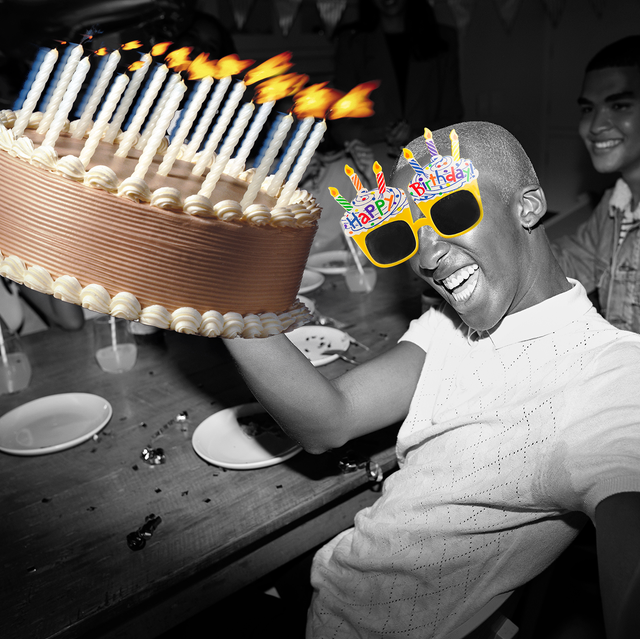 man holding cake with birthday glasses