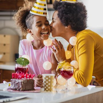 mother and daughter are in the kitchen celebrating birthday via video call