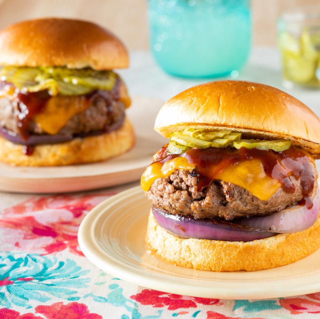 bison burger on white plate with burger behind