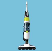 green and white bissell vacuum and steam mop hybrid with light blue background