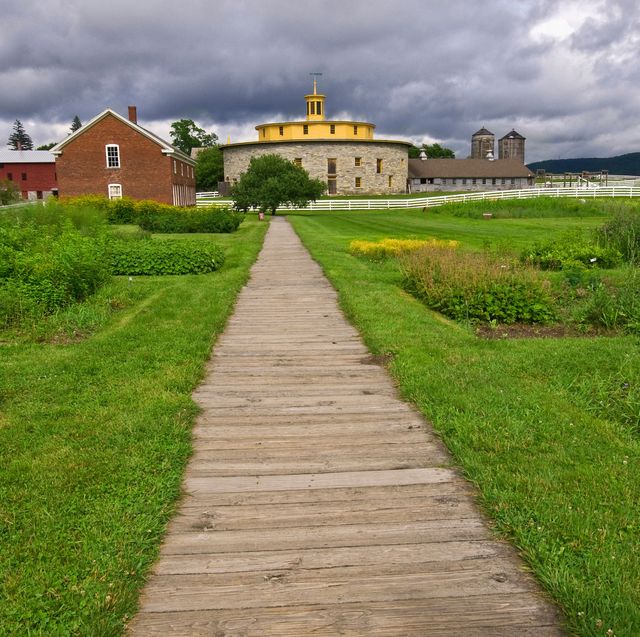 wood pathway leading to the round barn of the hancock shaker village in pittsfield, massachusetts, usa
