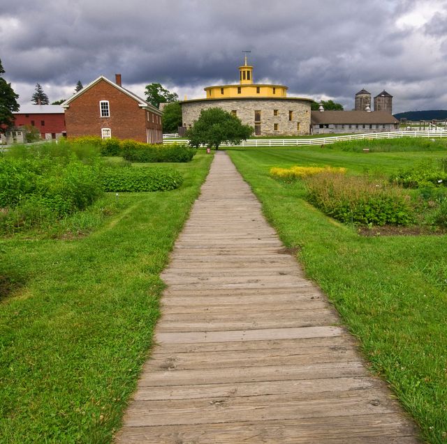 wood pathway leading to the round barn of the hancock shaker village in pittsfield, massachusetts, usa