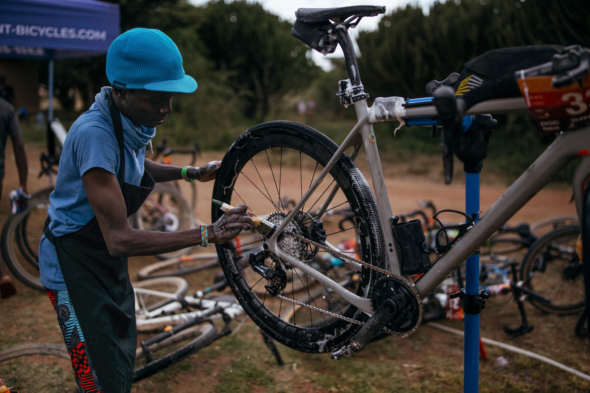 a bike mechanic works on a gravel bike