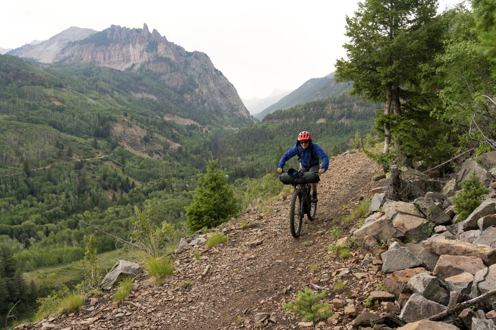 a rider bikes down the galloping goose trail before camping in calico hills