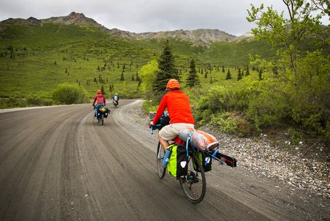 people bike the dirt and gravel portion of the road in denali on june 11, 2019