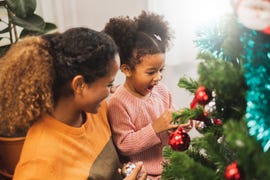 mother and her cute daughter decorating christmas tree for christmas and happy new concept