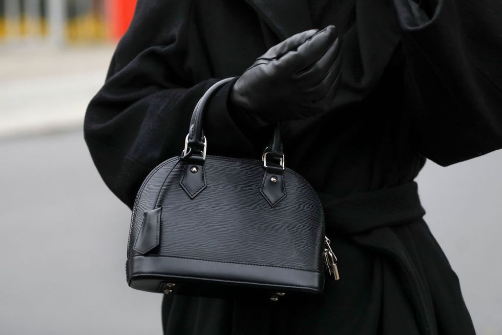 A black leather Louis Vuitton 'Alma' tote bag is seen during the News  Photo - Getty Images
