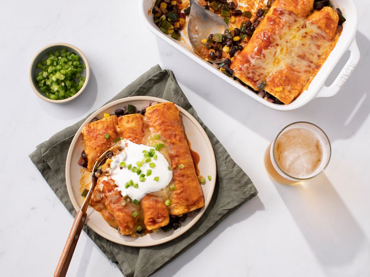 https://hips.hearstapps.com/hmg-prod/images/black-bean-enchiladas-with-poblano-peppers-1-ana-plefka-1-65580a53db293.jpg?crop=0.8888888888888888xw:1xh;center,top&resize=1200:*