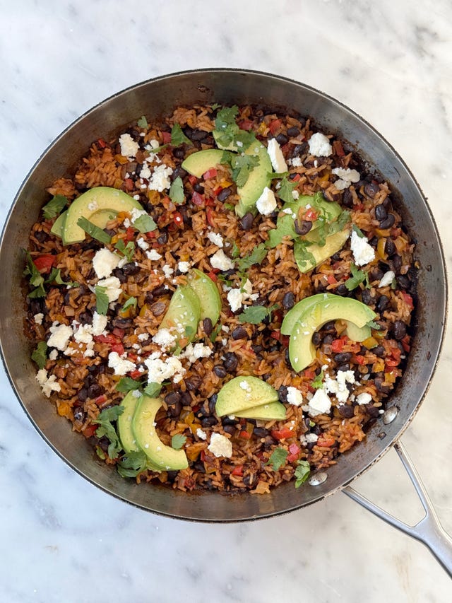 black bean, rice, avocados and cheese in a skillet
