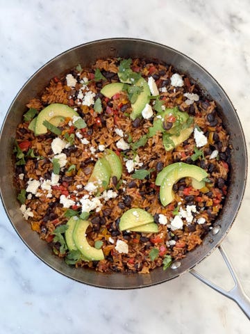 black bean, rice, avocados and cheese in a skillet