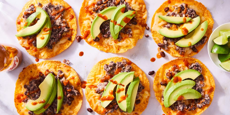 Tostadas topped with black beans, cheese and avocado slices