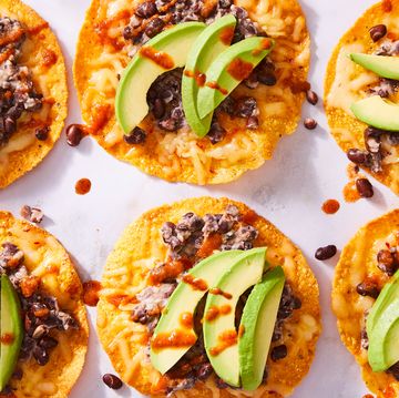 tostadas topped with black beans, cheese, and avocado slices