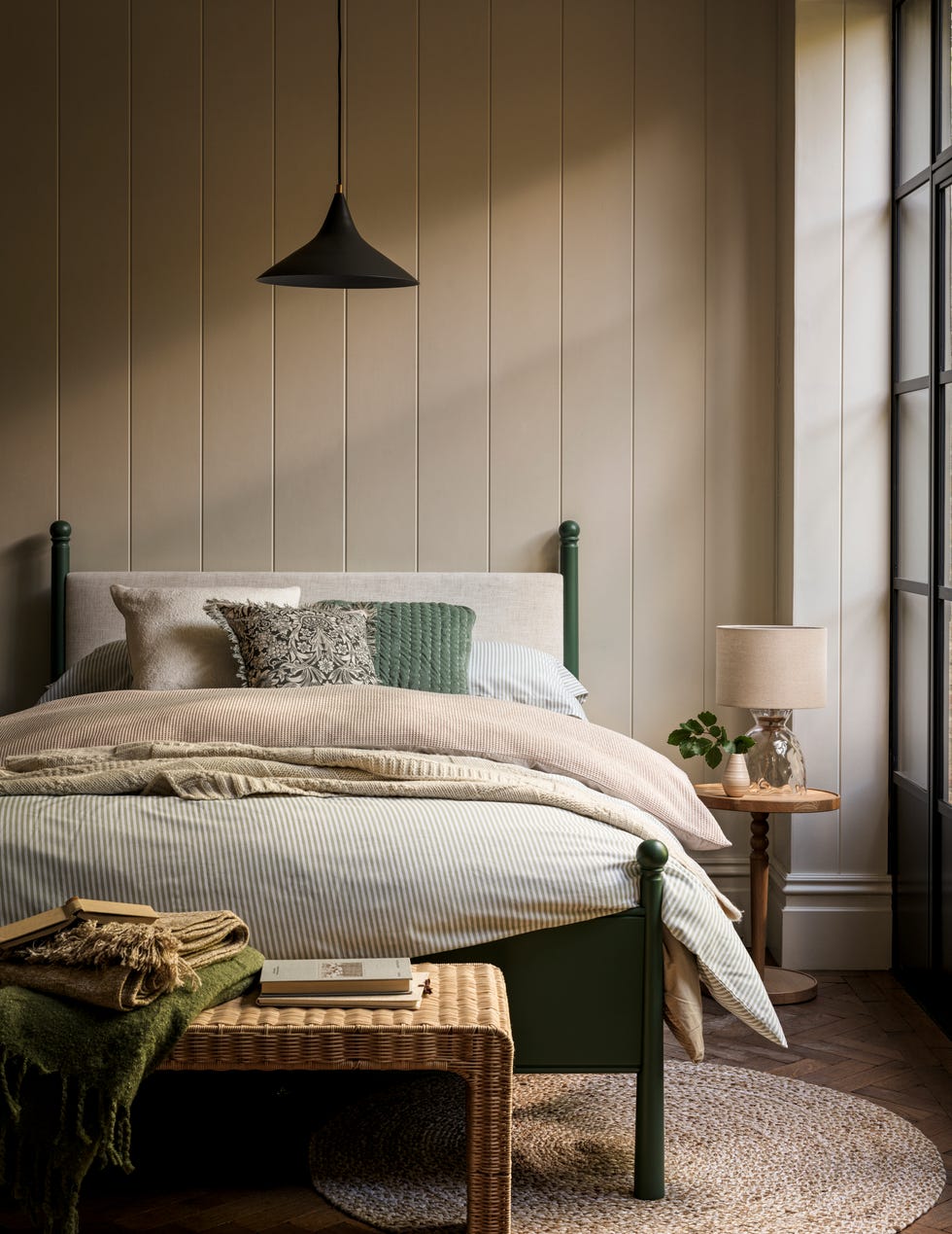 cream and green bedroom with a graphic black pendant