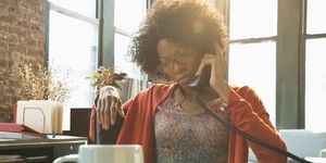 Black businesswoman talking on telephone at desk