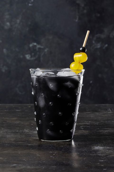 black charcoal lemonade with fruit on a skewer