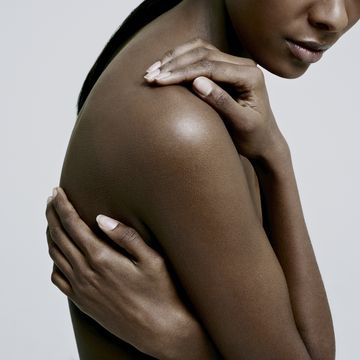 black female with hands on nude shoulder