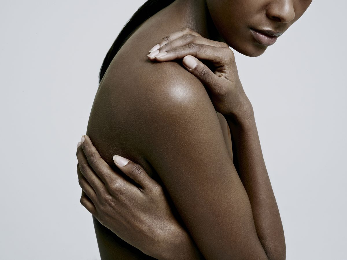 black female with hands on nude shoulder