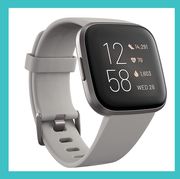 revlon one step volumizer and fitbit versa on white background with blue border