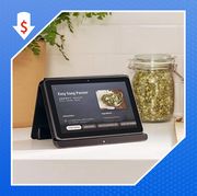 amazon fire hd 8 plus tablet on kitchen counter with sag paneer recipe on the screen and teal bose quietcomfort wireless earbuds