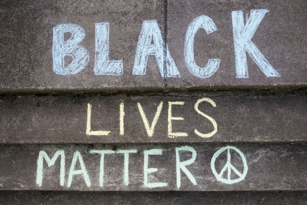 portland, oregon, usa   june 2nd, 2020 overhead shot of the saying black lives matter written on the sidewalk in colorful chalk