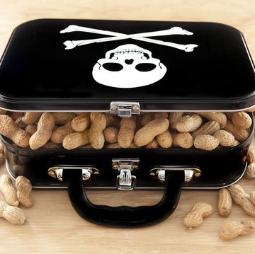 black lunchbox filled with peanuts