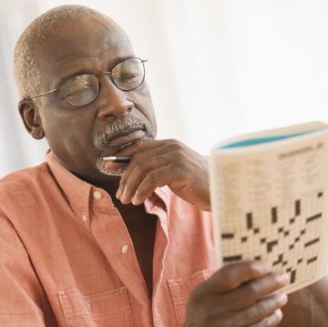 black man doing crossword puzzle