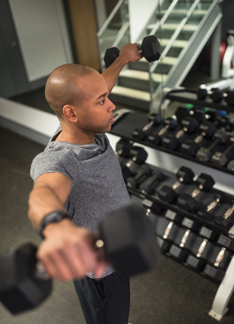 black man lifting weights in gym