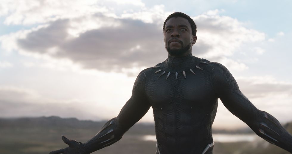 chadwick boseman as t'challa in black panther suit with arms open