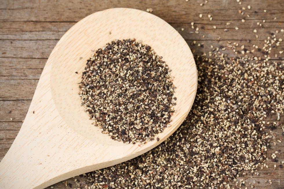 black pepper on wooden spoon