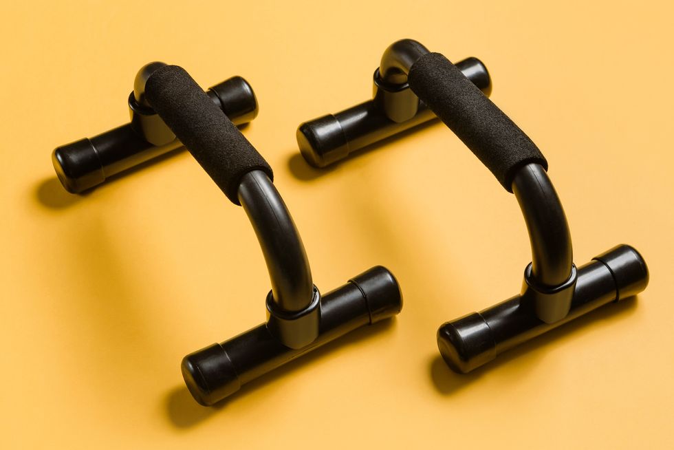 black push up bars on a yellow background