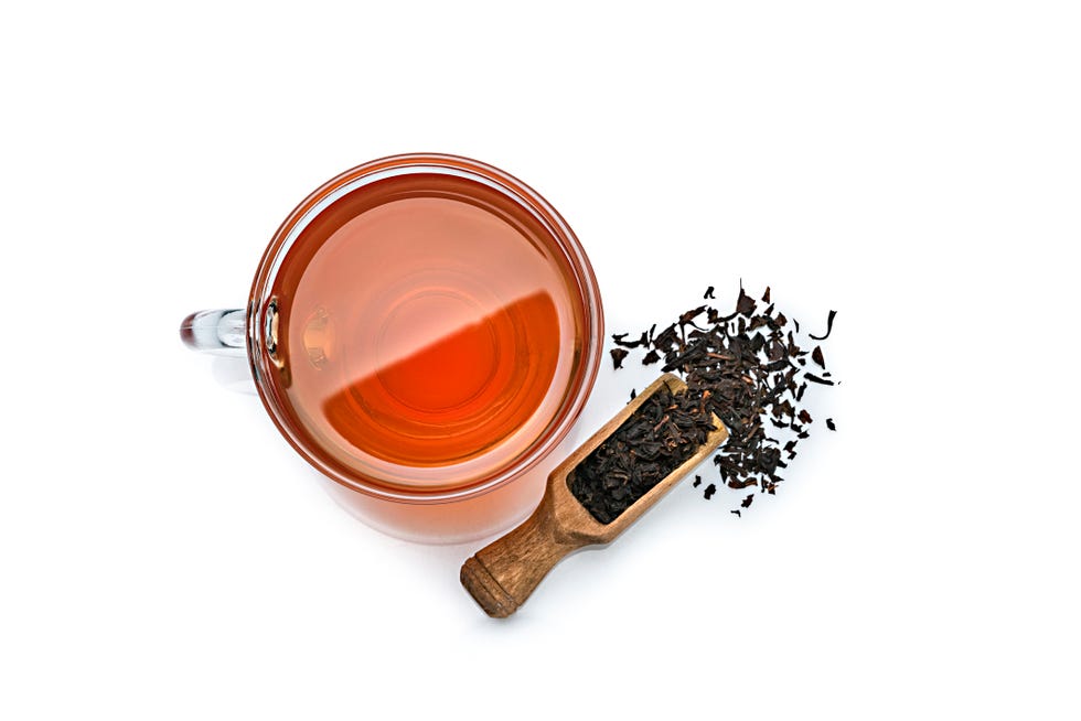 black tea cup shot from above on white background copy space