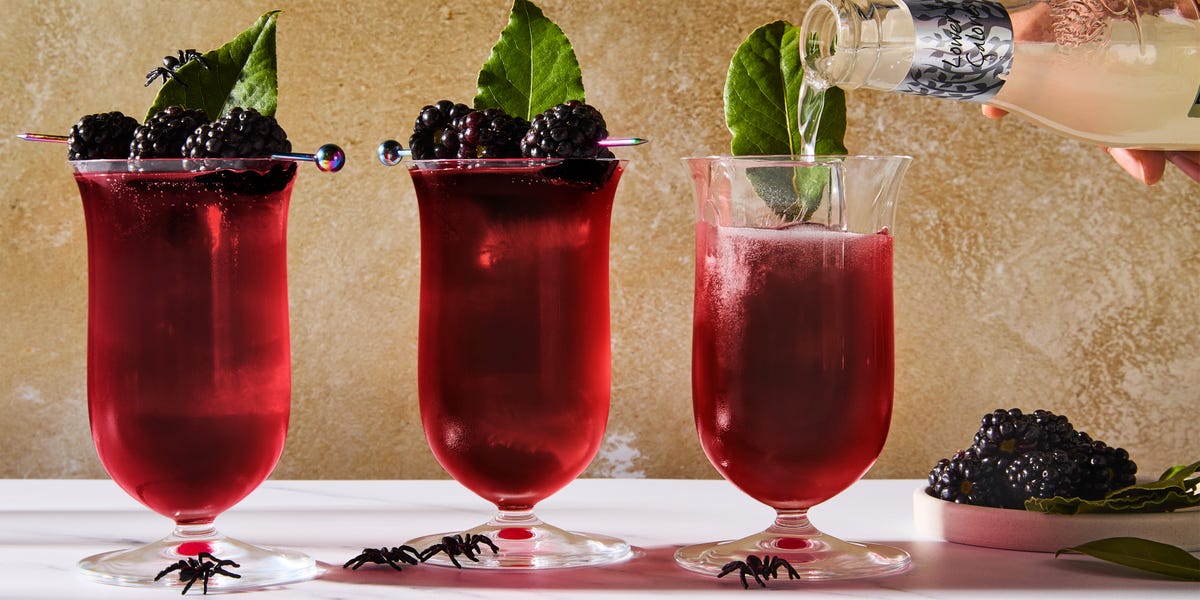 Black Widow Cocktail deep red cocktail topped with blackberries and bay leaves
