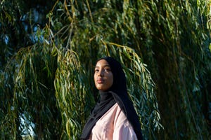 black woman in hijab in nature