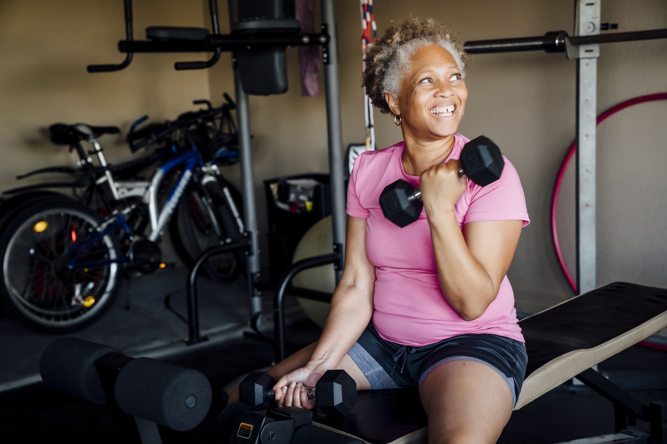 https://hips.hearstapps.com/hmg-prod/images/black-woman-lifting-weights-in-garage-royalty-free-image-1677604364.jpg