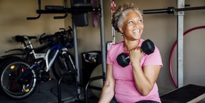 black woman lifting weights in garage