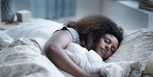 black woman sleeping in bed