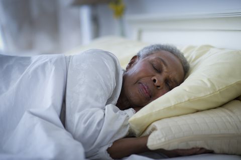 black woman sleeping in bed