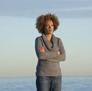 black woman standing near ocean