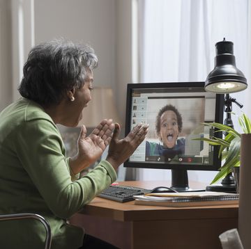 a grandma video chats with her grandson on a computer