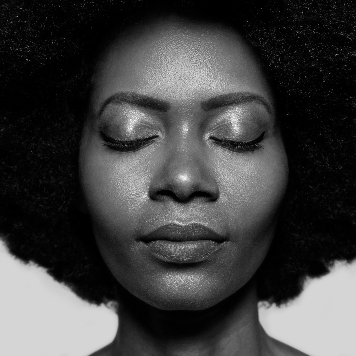 black woman with fro and eyes closed