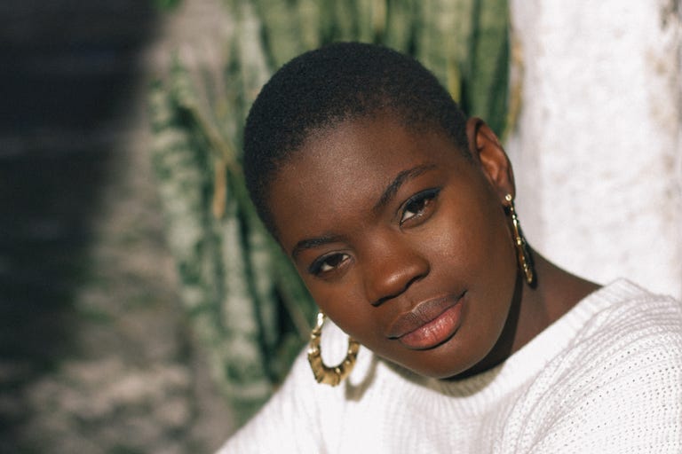 black young woman looking at camera