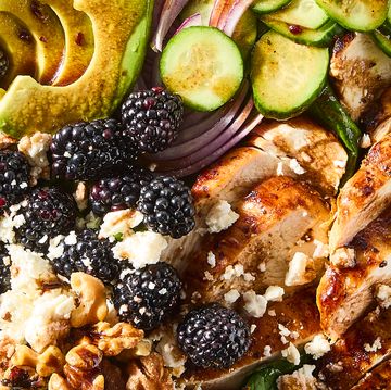 salad with sliced chicken, blackberries, sliced cucumber, red onion, and walnuts