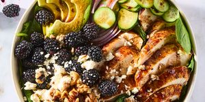 salad with sliced chicken, blackberries, sliced cucumber, red onion, and walnuts