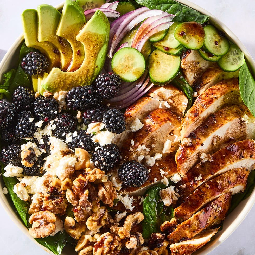 Salad with chicken fillets, blackberries, gherkin slices, red onions and walnuts