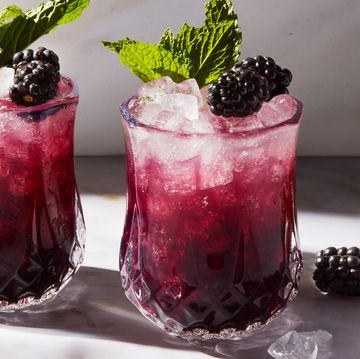 purple blackberry mint julep with crushed ice garnished with a blackberry and mint sprig